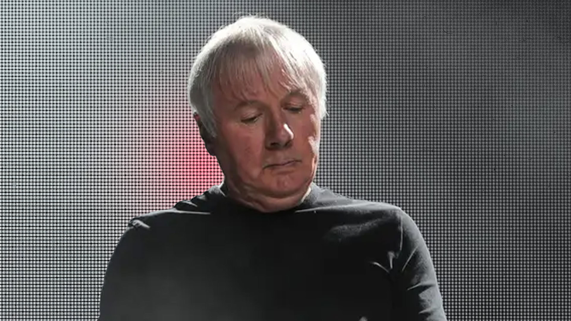 Billy Currie playing keyboard during a live concert.