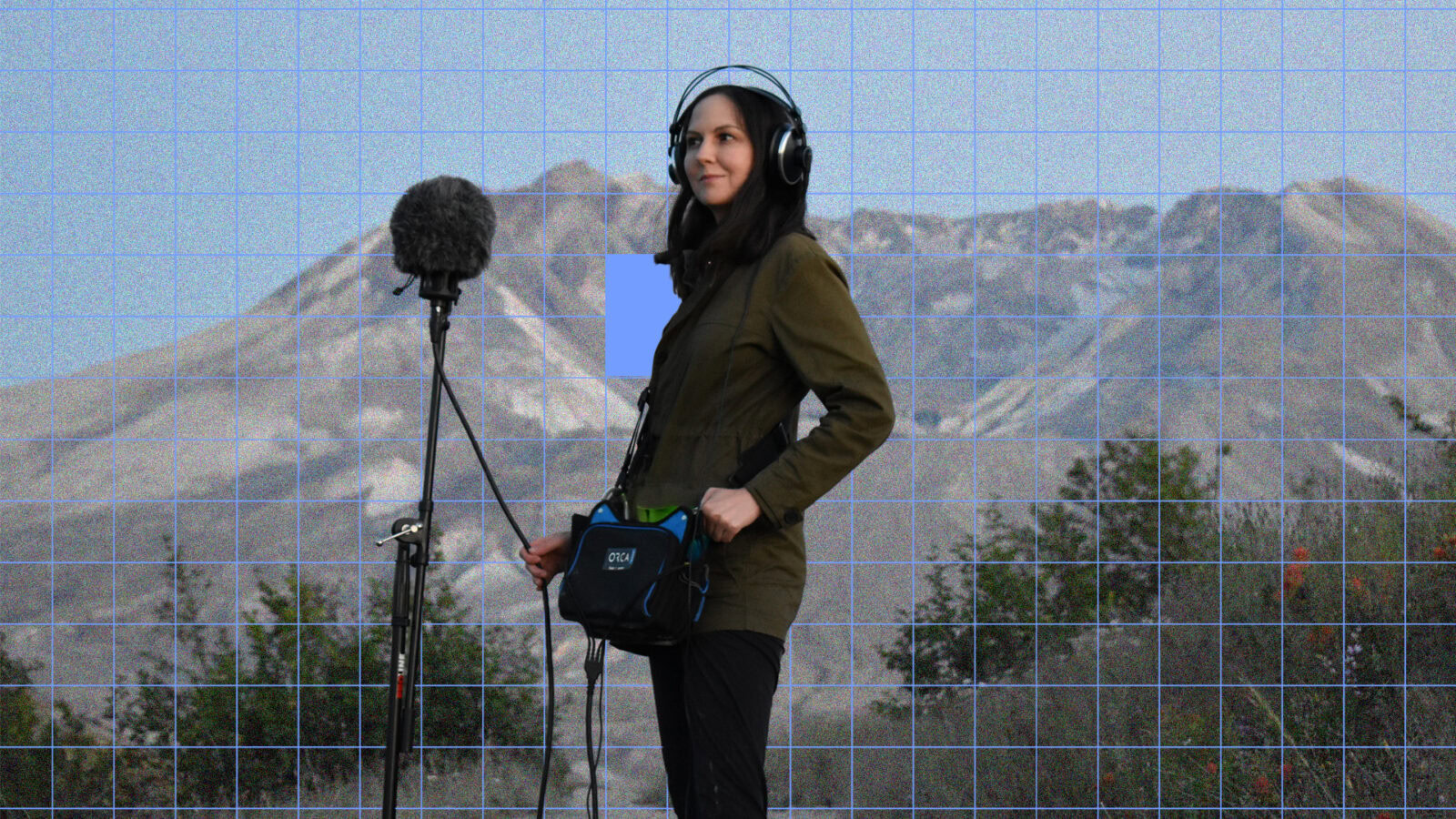 Patricia Wolf with headphones recording sound outdoors in front of mountains.