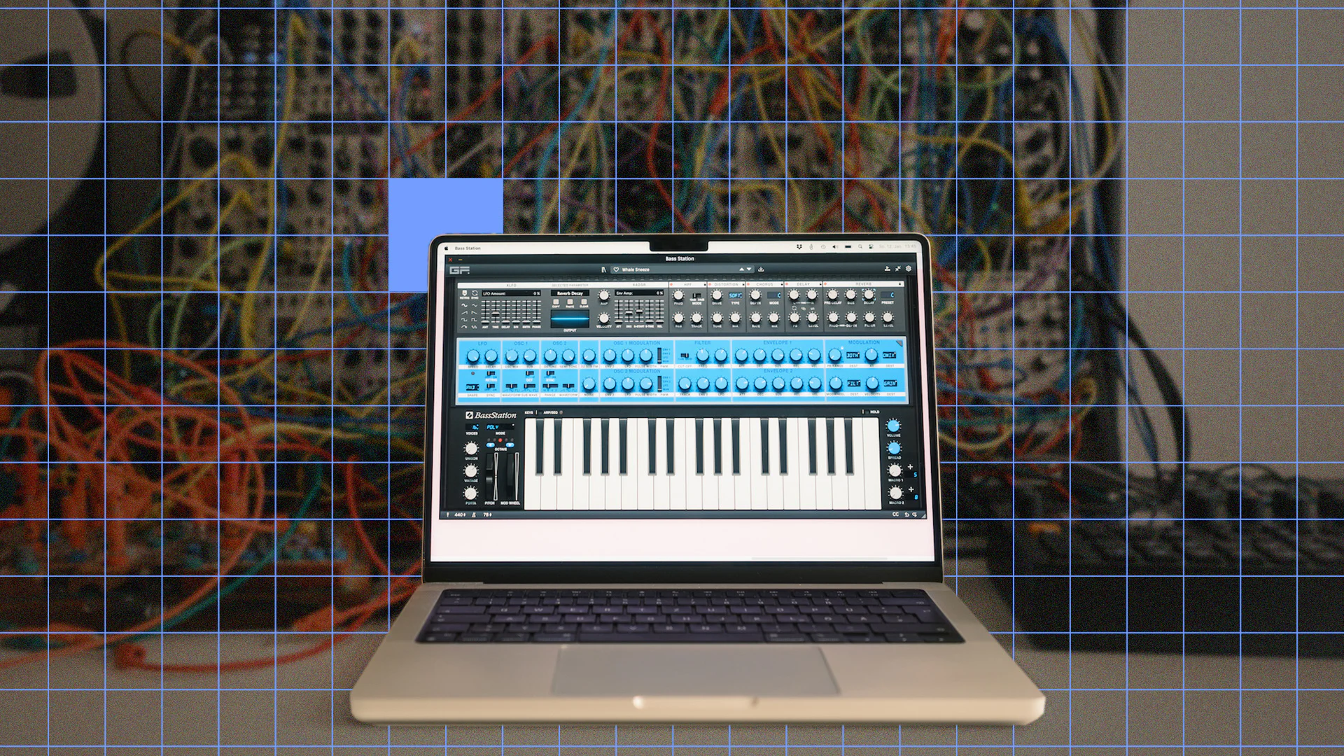 Laptop displaying GForce Software synthesizer interface with patch cables background.