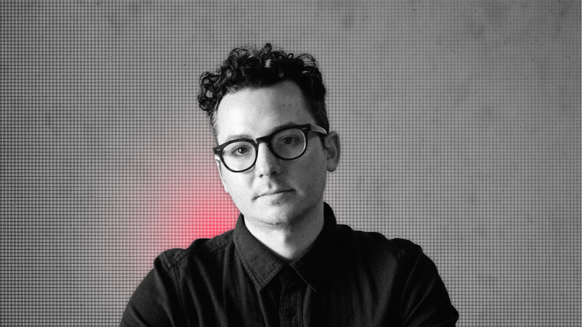 Portrait of Ian Hultquist in studio with a neutral background.